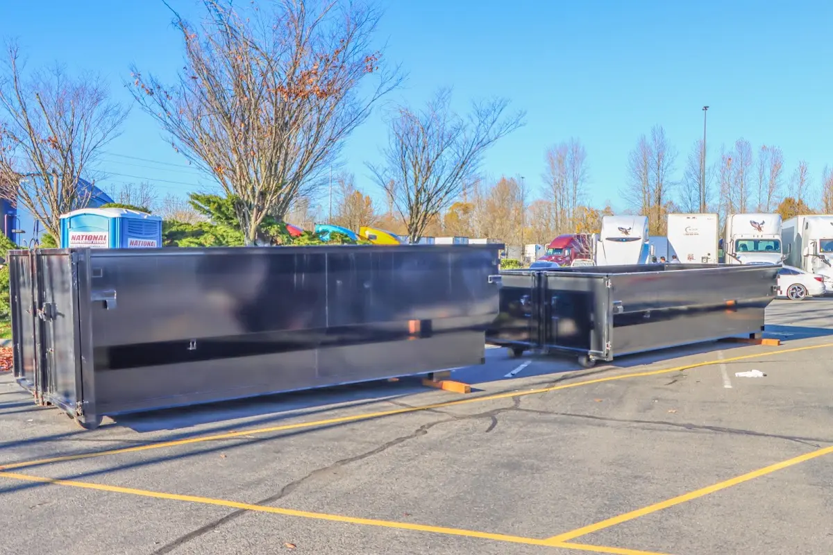 Professional dumpster rental service with roll-off container on residential driveway in South Williamsport